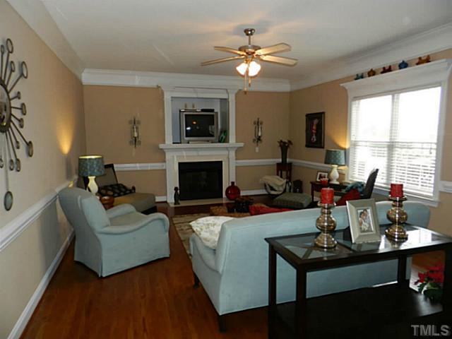 343 Ina Joe Place Willow Spring, NC 27592 - Photo 5 of 23 a living room with furniture flat screen tv and a fireplace