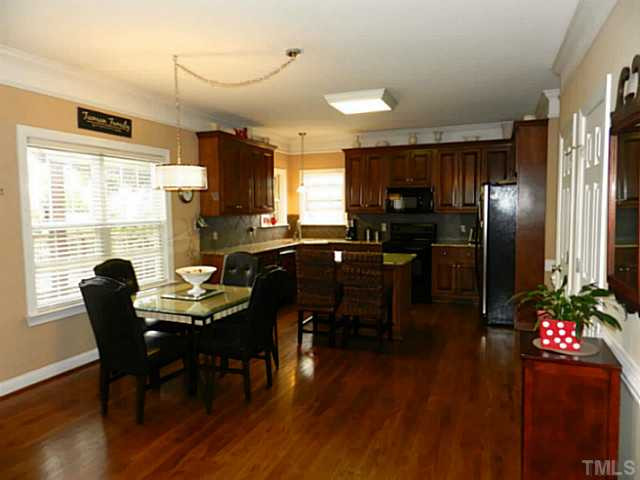 343 Ina Joe Place Willow Spring, NC 27592 - Photo 7 of 23 a view of a dining room with furniture window and wooden floor