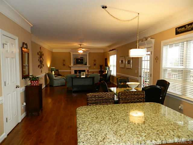 343 Ina Joe Place Willow Spring, NC 27592 - Photo 9 of 23 a living room with fireplace furniture and a large window
