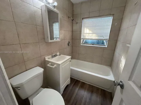 a bathroom with a toilet a sink and bathtub