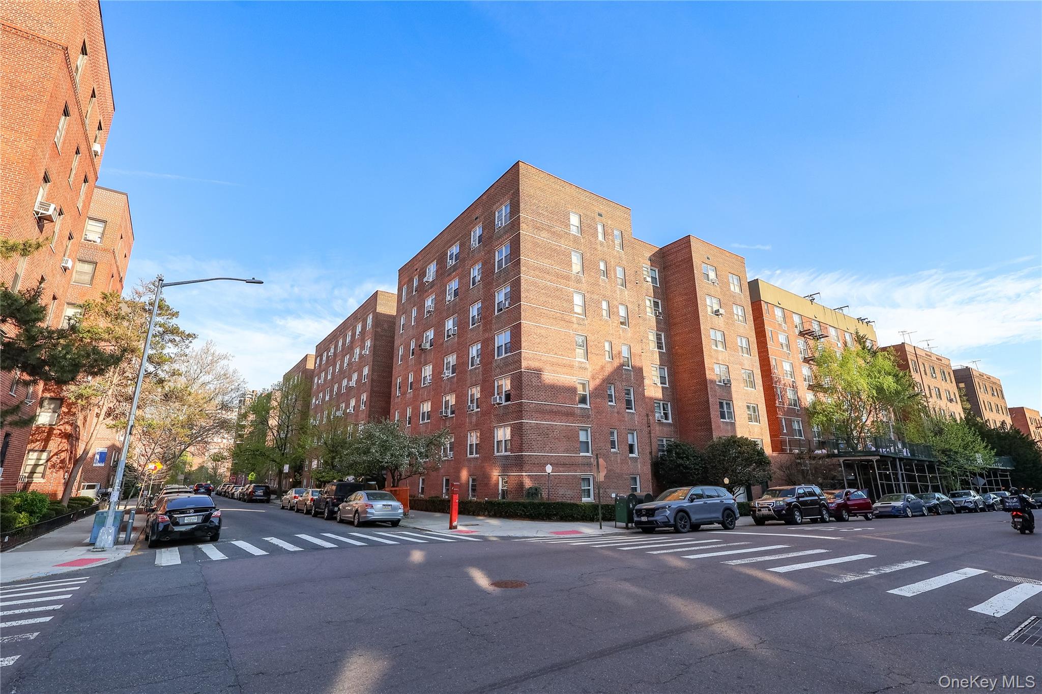 67-40 Booth Street, Unit 4O Queens, NY 11375 - Photo 1 of 19 a city street with tall buildings in the background