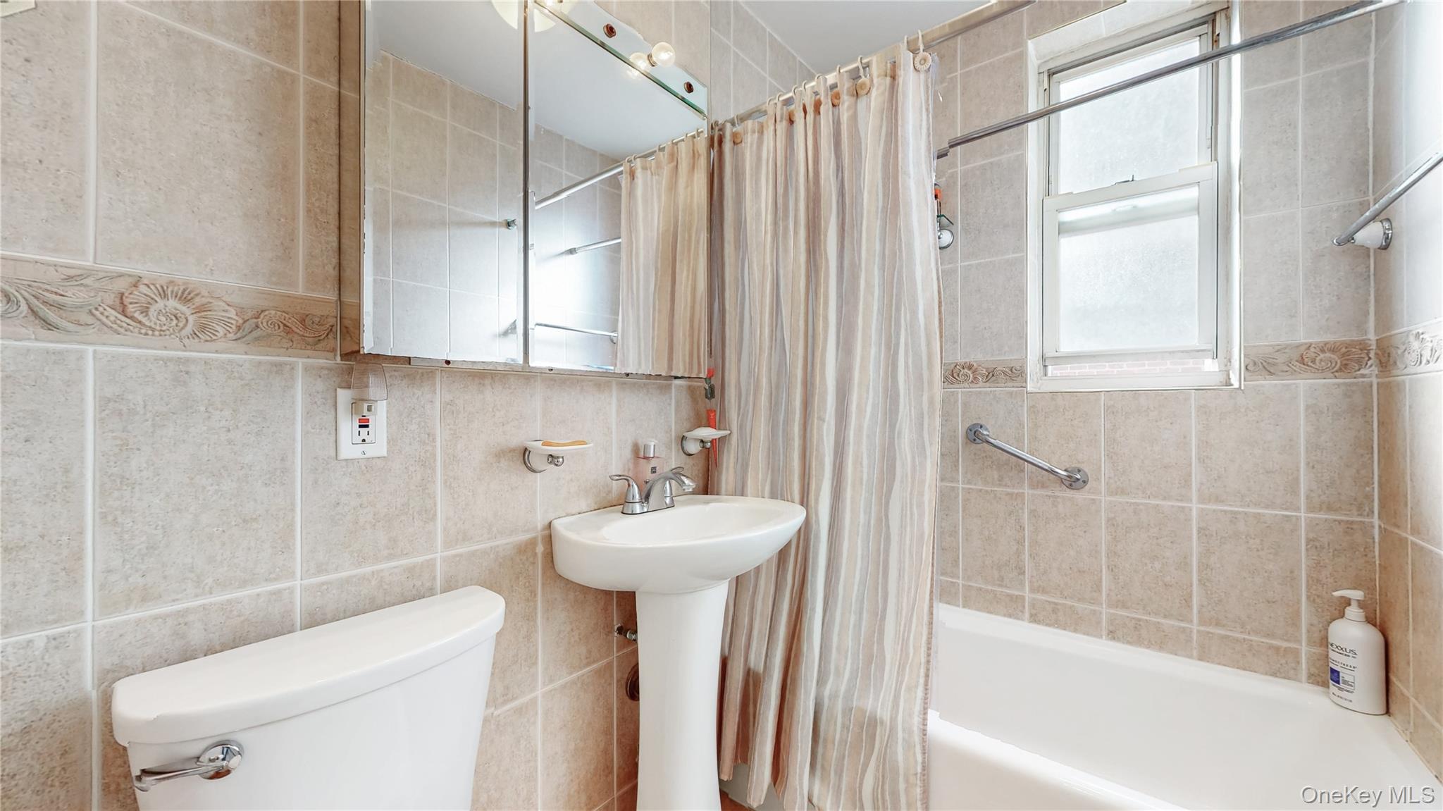 67-40 Booth Street, Unit 4O Queens, NY 11375 - Photo 16 of 19 a bathroom with a sink toilet and shower