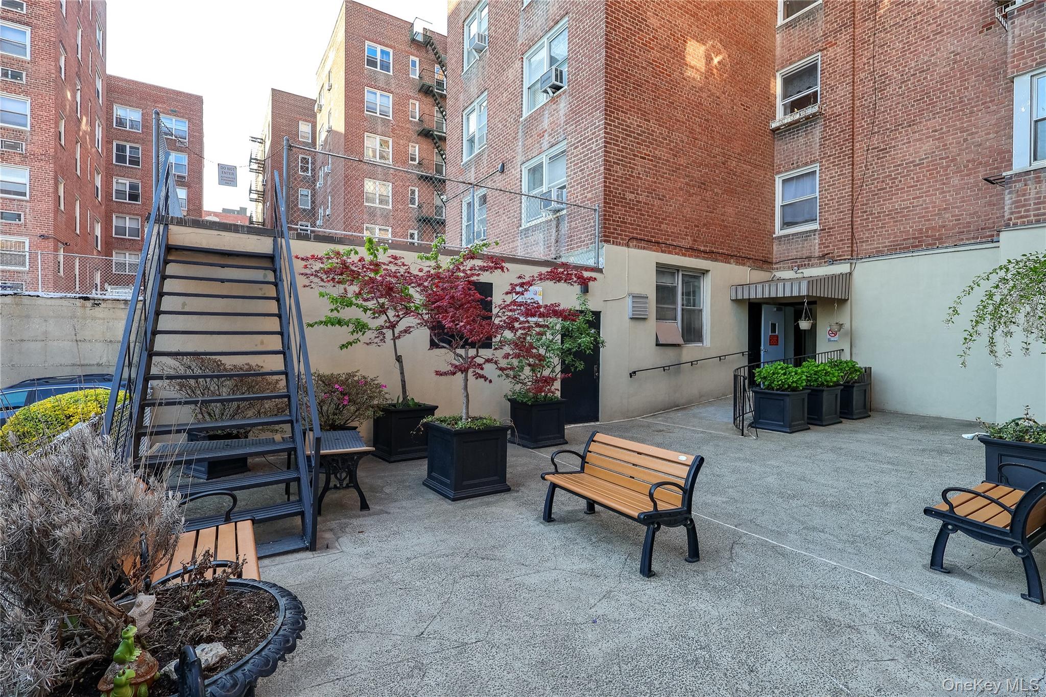 67-40 Booth Street, Unit 4O Queens, NY 11375 - Photo 18 of 19 a backyard of a house with barbeque oven table and chairs