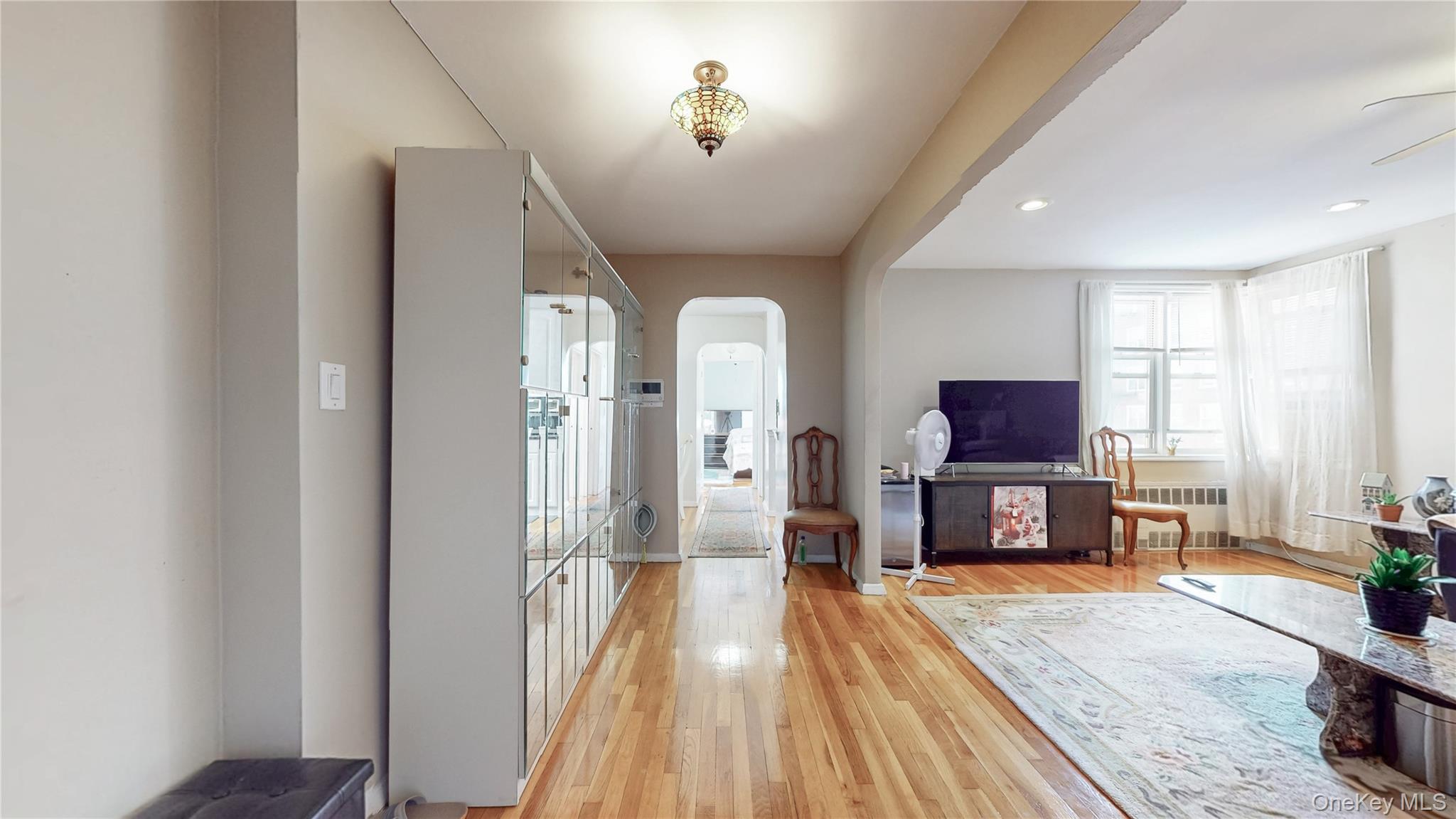 67-40 Booth Street, Unit 4O Queens, NY 11375 - Photo 4 of 19 a view of a livingroom with furniture and a flat screen tv