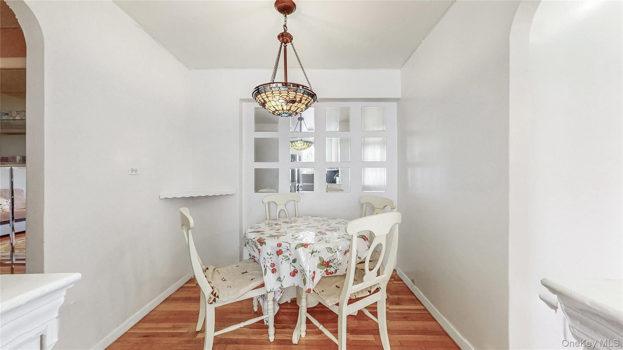 67-40 Booth Street, Unit 4O Queens, NY 11375 - Photo 10 of 19 a view of a dining room with furniture and wooden floor