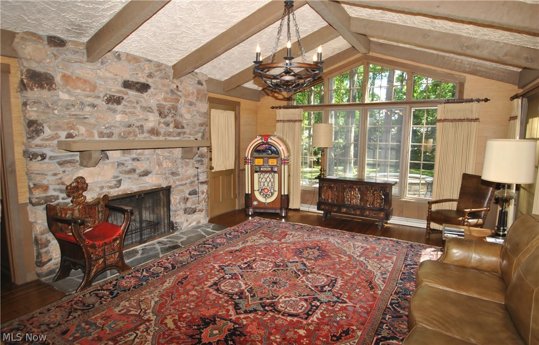 2250 Lancaster Road Akron, OH 44313 - Photo 9 of 35 Family room has beamed cathedral ceiling, pegged wood floors, impressive natural stone fireplace and doors leading to porch or patio.