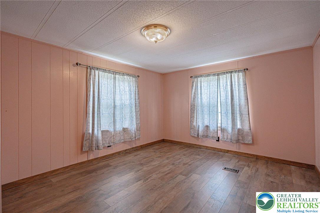 3310 Friedens Road Slatington, PA 18080 - Photo 17 of 41 an empty room with wooden floor and windows