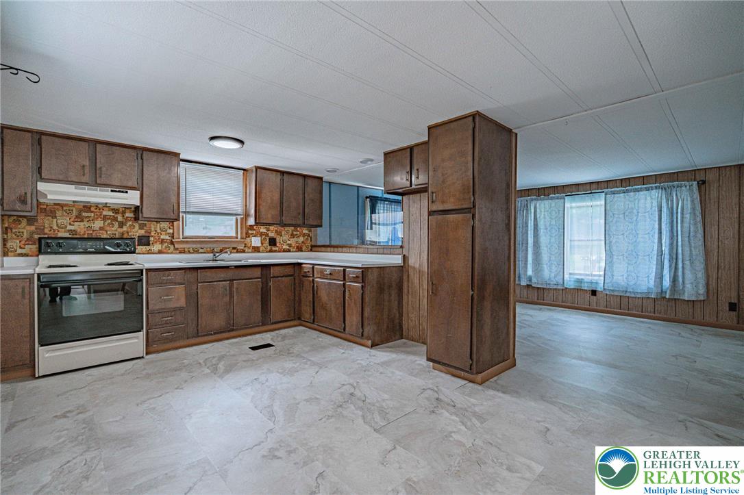 3310 Friedens Road Slatington, PA 18080 - Photo 8 of 41 a kitchen with stainless steel appliances granite countertop a stove a sink dishwasher a refrigerator and a microwave oven