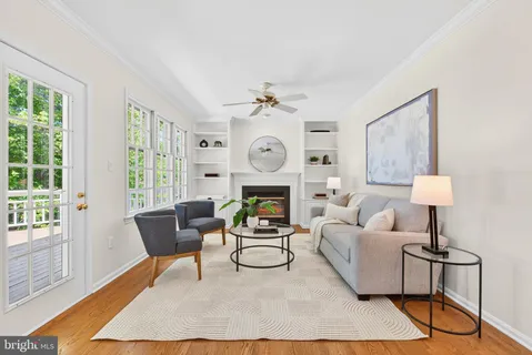 a living room with furniture a chandelier and a rug