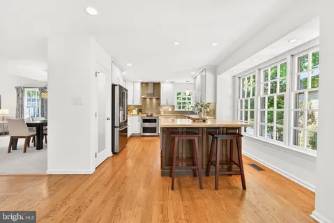 a dining room with furniture and wooden floor