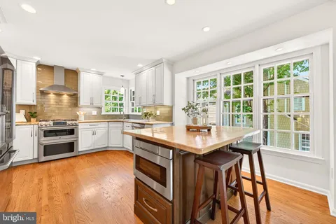 a kitchen with a sink a stove and a refrigerator