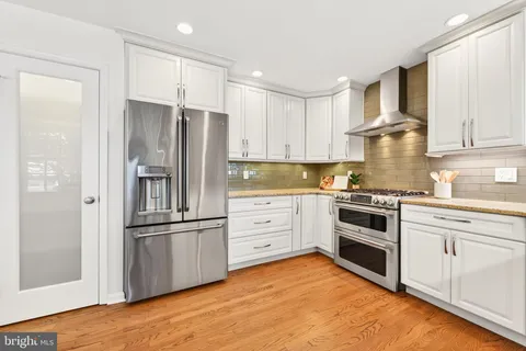 a kitchen with granite countertop stainless steel appliances and cabinets