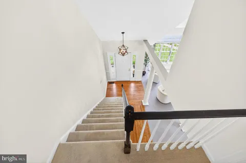 a view of staircase with white walls and a window