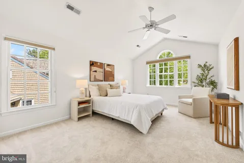 a bed room with a bed and a chandelier