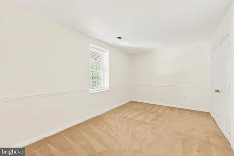 an empty room with a empty space and a window