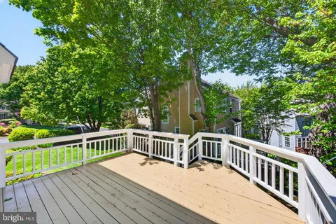 a view of a wooden deck with trees