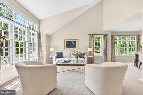 a living room with furniture and large windows