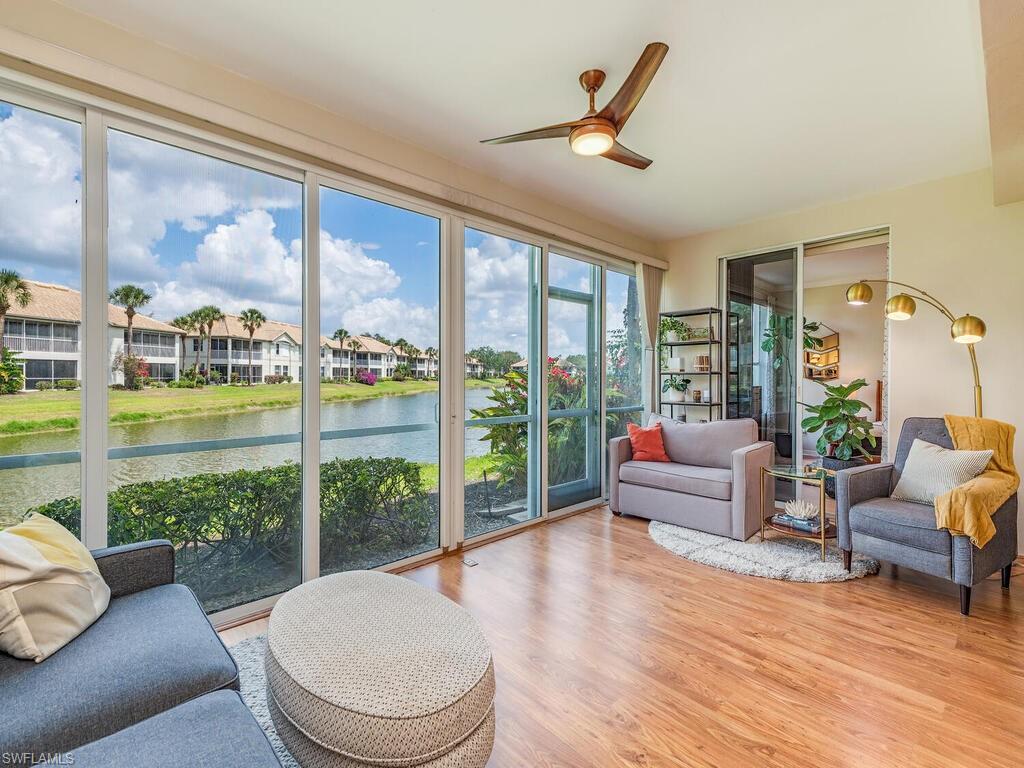 a living room with furniture and a floor to ceiling window