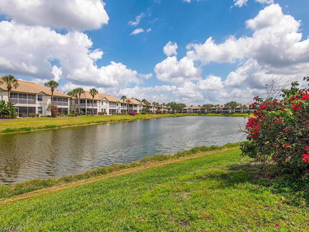 7756 Gardner Drive, Unit 102 Naples, FL 34109 - Photo 11 of 16 a view of a lake with houses in the back