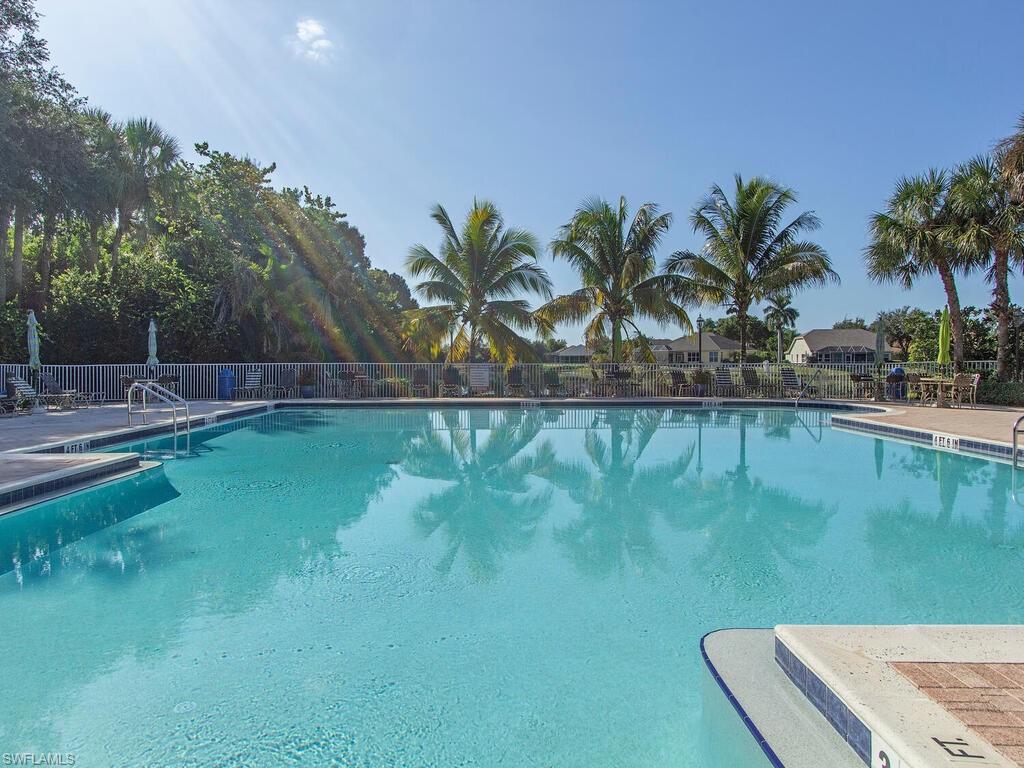 7756 Gardner Drive, Unit 102 Naples, FL 34109 - Photo 13 of 16 a view of a lake with a yard