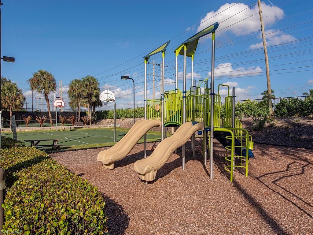 7756 Gardner Drive, Unit 102 Naples, FL 34109 - Photo 16 of 16 a park view with a bench