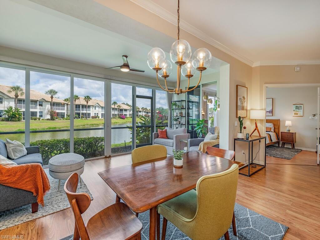 7756 Gardner Drive, Unit 102 Naples, FL 34109 - Photo 2 of 16 a view of a dining room with furniture large windows and wooden floor