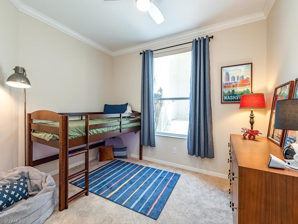 7756 Gardner Drive, Unit 102 Naples, FL 34109 - Photo 9 of 16 a bedroom with furniture and a window