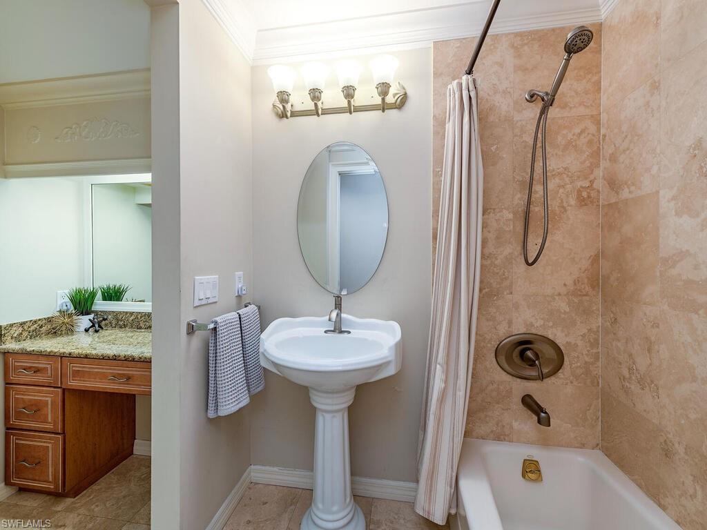 7756 Gardner Drive, Unit 102 Naples, FL 34109 - Photo 10 of 16 a bathroom with a sink a toilet and shower