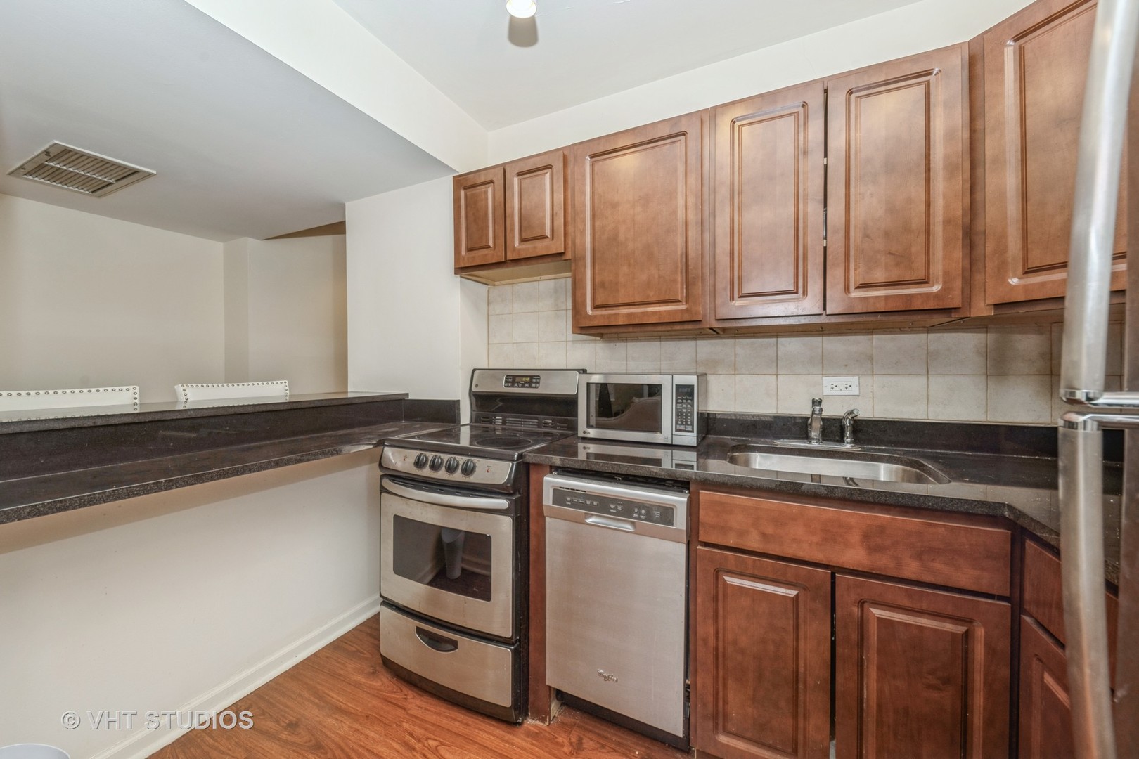 260 East Chestnut Street, Unit 606 Chicago, IL 60611 - Photo 14 of 27 a kitchen with stainless steel appliances granite countertop a stove a sink and cabinets