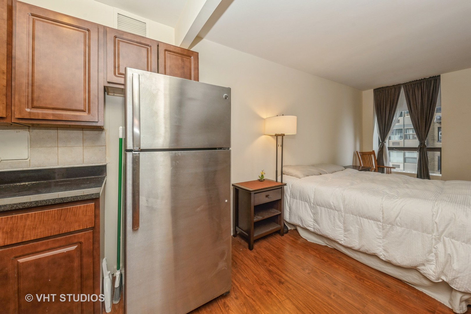 260 East Chestnut Street, Unit 606 Chicago, IL 60611 - Photo 16 of 27 a bedroom with a bed and a refrigerator