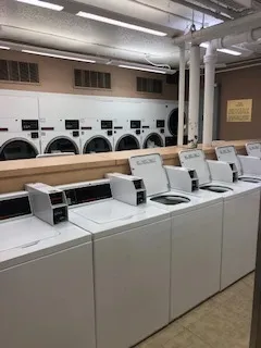 a hallway with white cabinets and sink