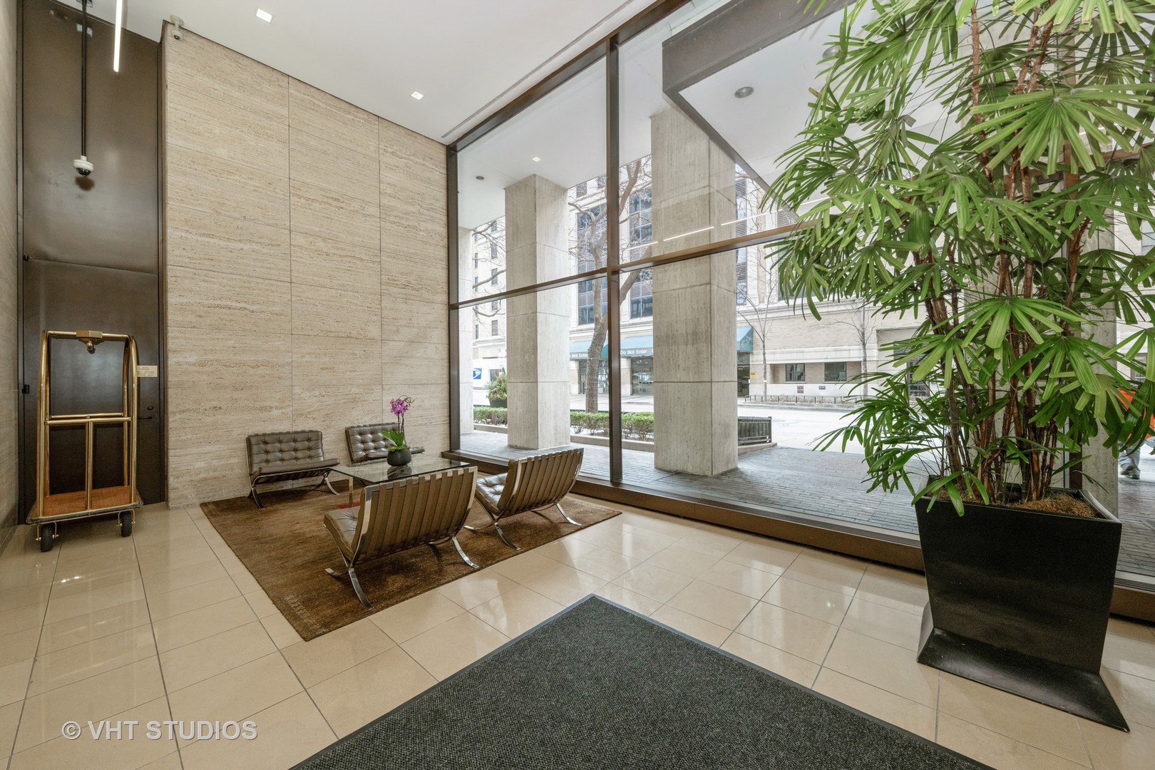 260 East Chestnut Street, Unit 606 Chicago, IL 60611 - Photo 3 of 27 a lobby with furniture and a potted plant