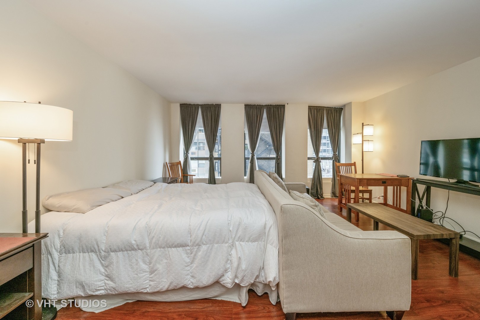 260 East Chestnut Street, Unit 606 Chicago, IL 60611 - Photo 8 of 27 a bedroom with a bed couch and a window