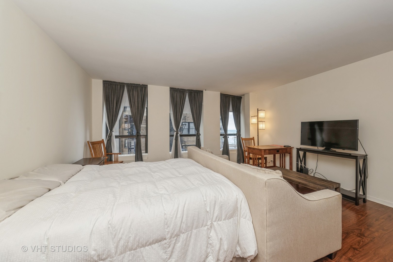 260 East Chestnut Street, Unit 606 Chicago, IL 60611 - Photo 9 of 27 a bedroom with a bed and a television in it