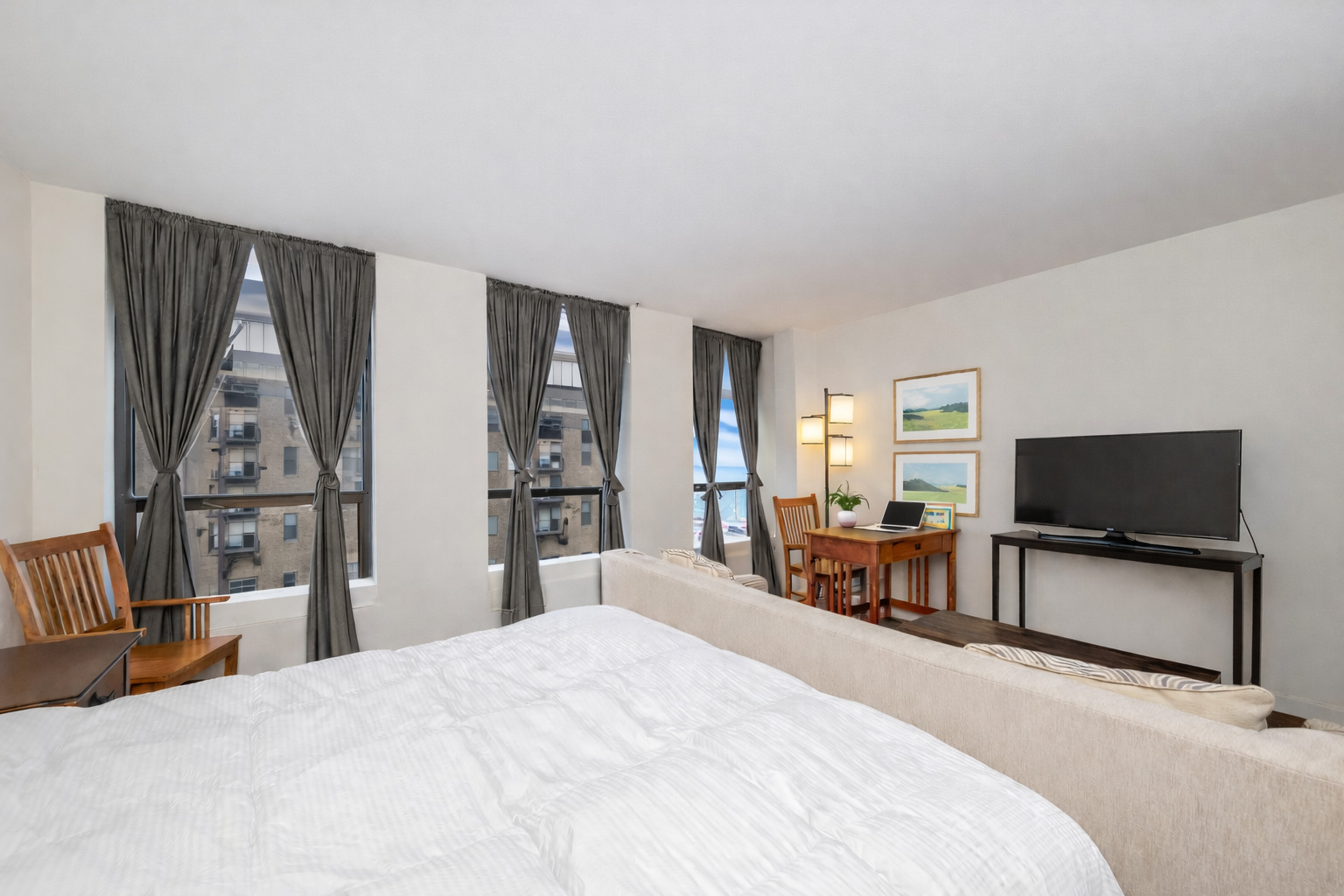 260 East Chestnut Street, Unit 606 Chicago, IL 60611 - Photo 9 of 26 a bedroom with a bed and a flat tv screen on dresser