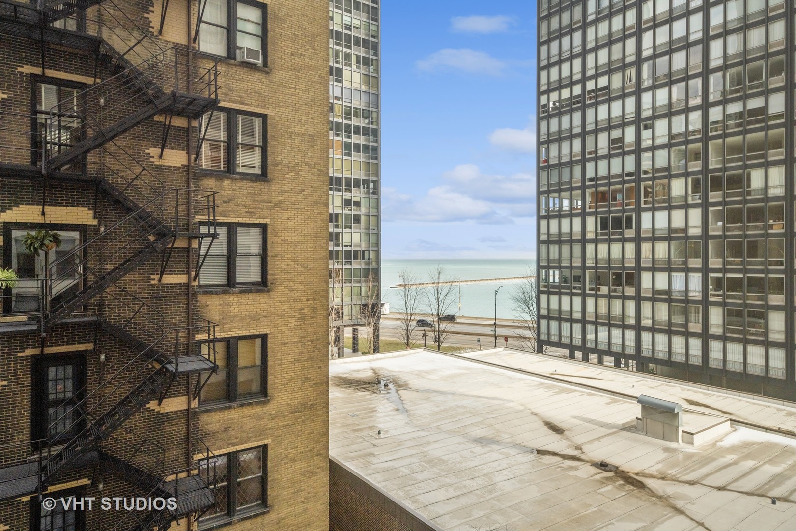 260 East Chestnut Street, Unit 606 Chicago, IL 60611 - Photo 10 of 26 a view of a balcony with a couple of cars parked on road