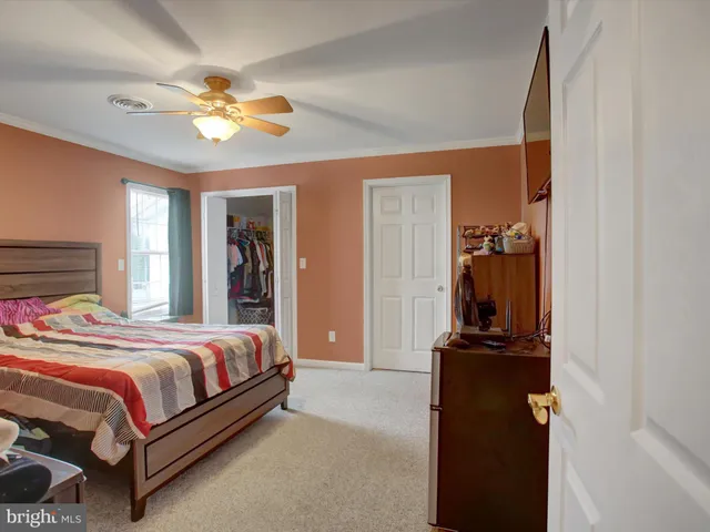 a view of walk in closet with clothes