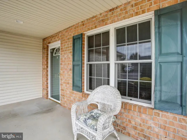 a front view of a house with seating space