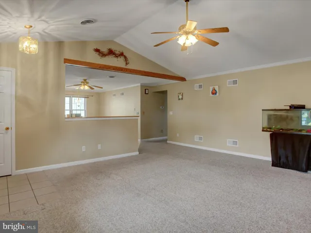 a view of a room with a ceiling fan and a window