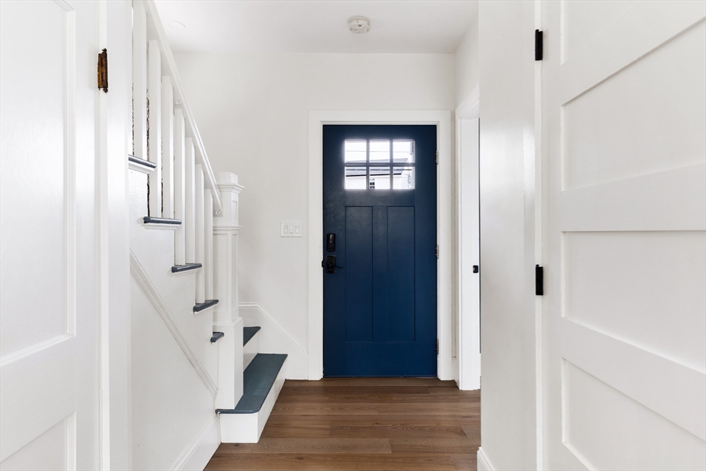 94 Sachem Road Needham, MA 02494 - Photo 13 of 33 a view of a hallway with wooden floor and staircase