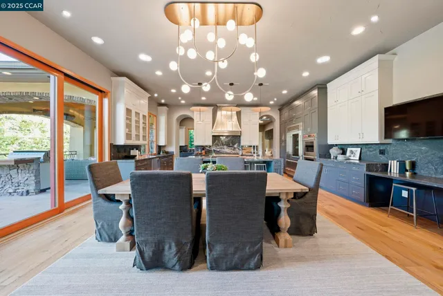 a kitchen with kitchen island granite countertop a stove and large window