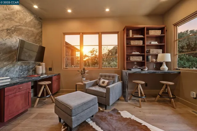 a bathroom with a granite countertop sink a toilet a mirror and bathtub