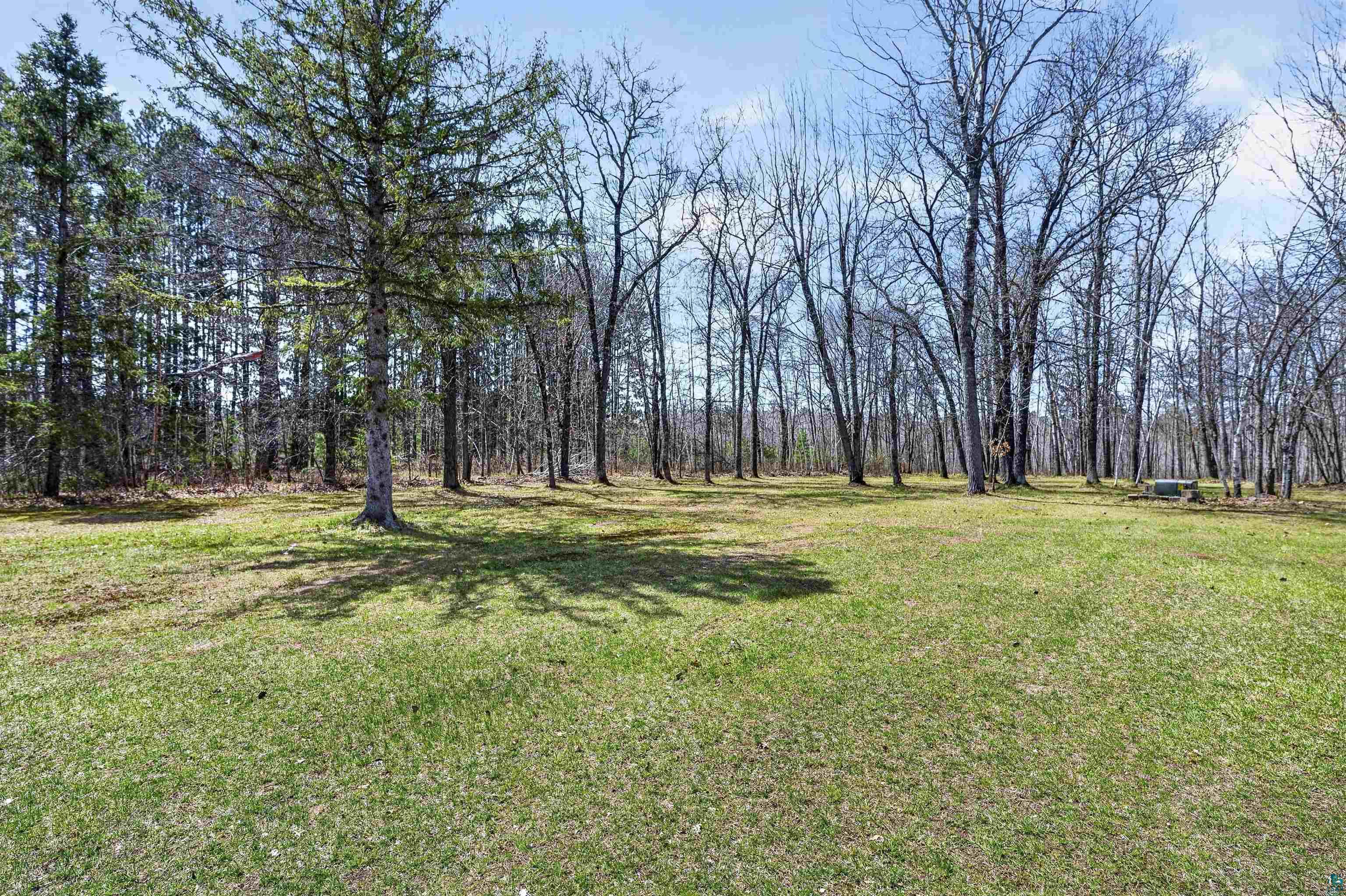 12235 East Crooked Lake Road Gordon, WI 54838 - Photo 33 of 48 Expansive green lawn surrounded by mature trees