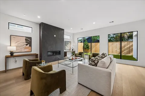 a living room with furniture a large window and a flat screen tv