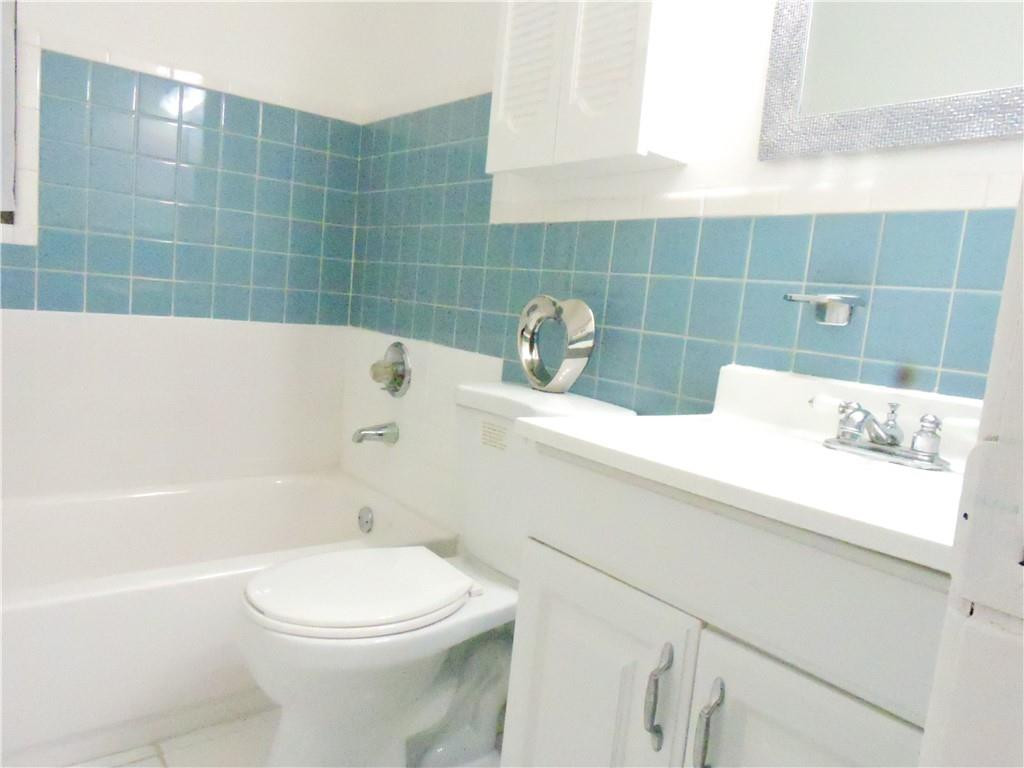 3384 Northwest 17th Street Lauderhill, FL 33311 - Photo 12 of 24 a bathroom with a sink a toilet and shower