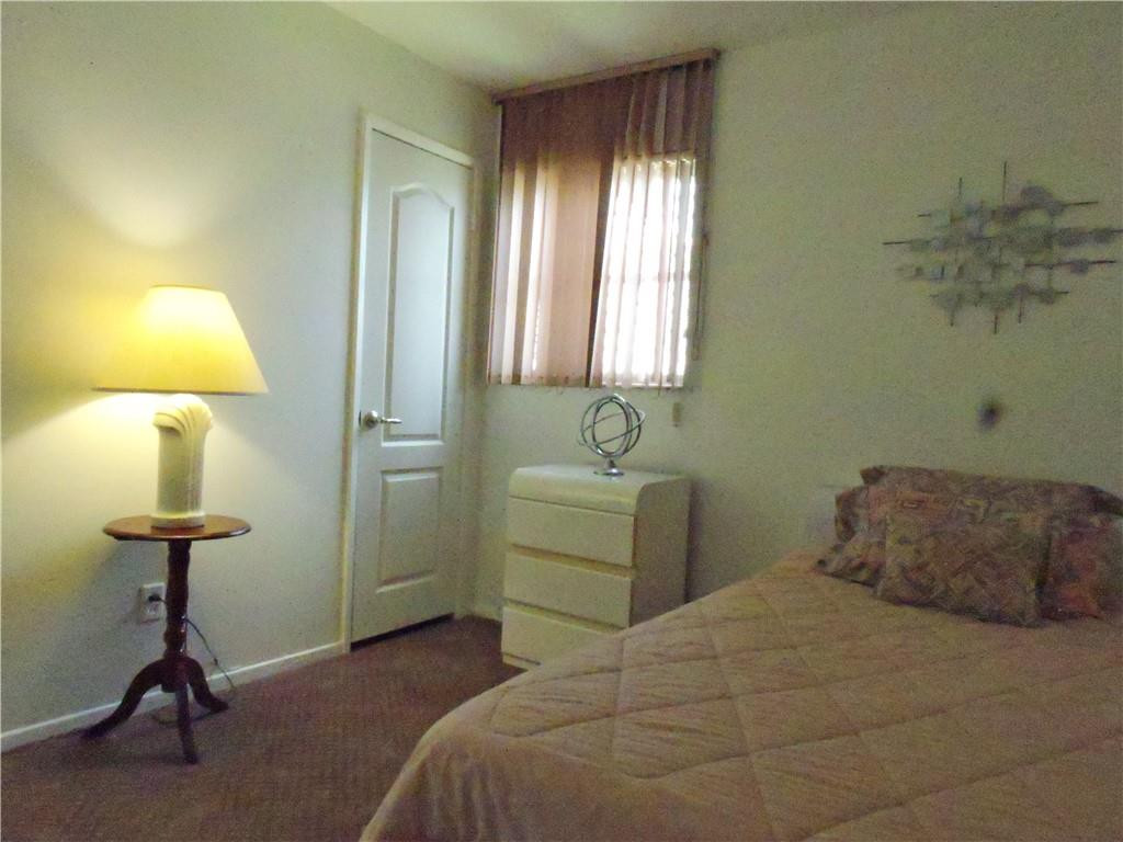 3384 Northwest 17th Street Lauderhill, FL 33311 - Photo 15 of 24 a bedroom with a bed and a table in it
