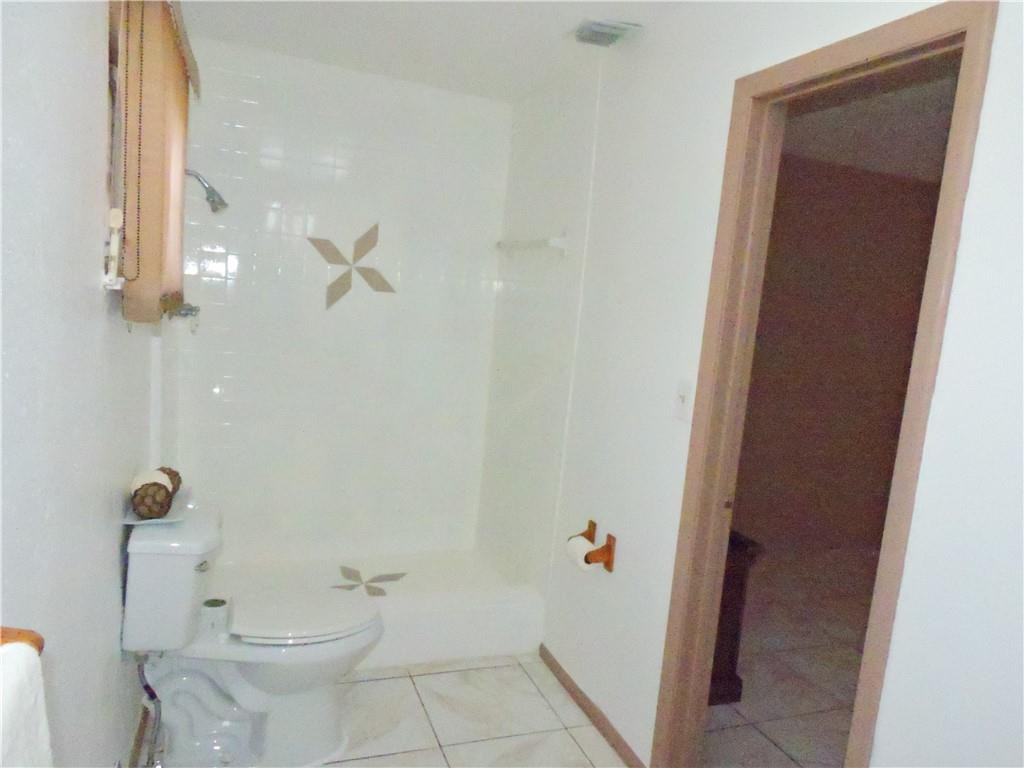 3384 Northwest 17th Street Lauderhill, FL 33311 - Photo 17 of 24 a bathroom with a toilet and a shower