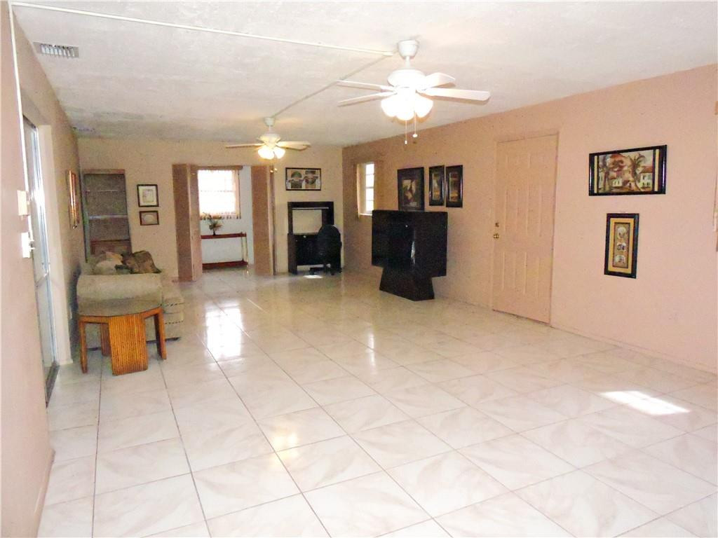 3384 Northwest 17th Street Lauderhill, FL 33311 - Photo 18 of 24 a view of a livingroom with furniture and a chandelier