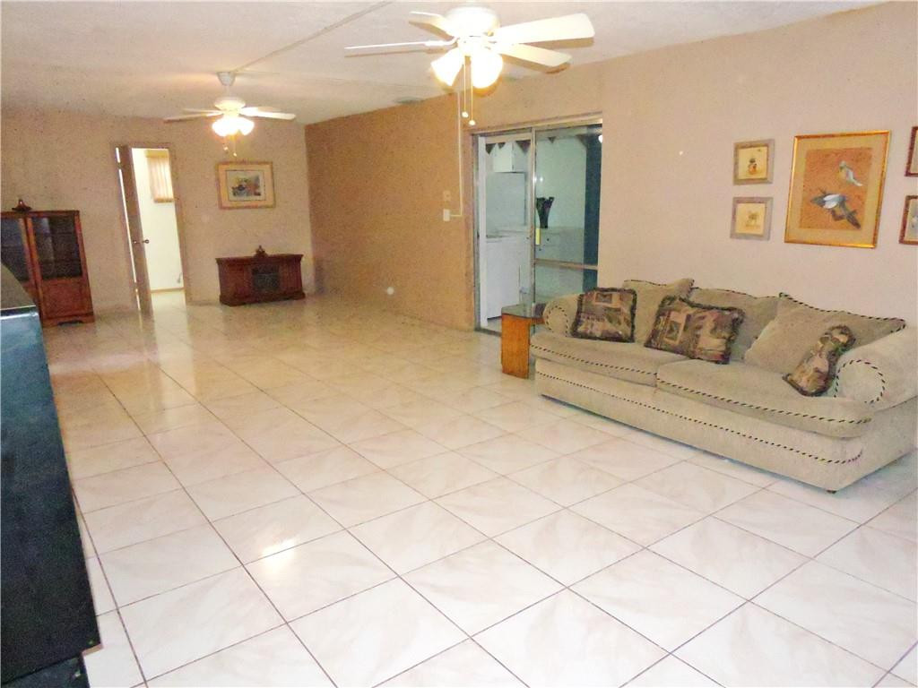 3384 Northwest 17th Street Lauderhill, FL 33311 - Photo 20 of 24 a living room with furniture and a chandelier