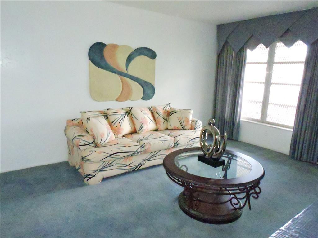 3384 Northwest 17th Street Lauderhill, FL 33311 - Photo 6 of 24 a living room with furniture a window and a table